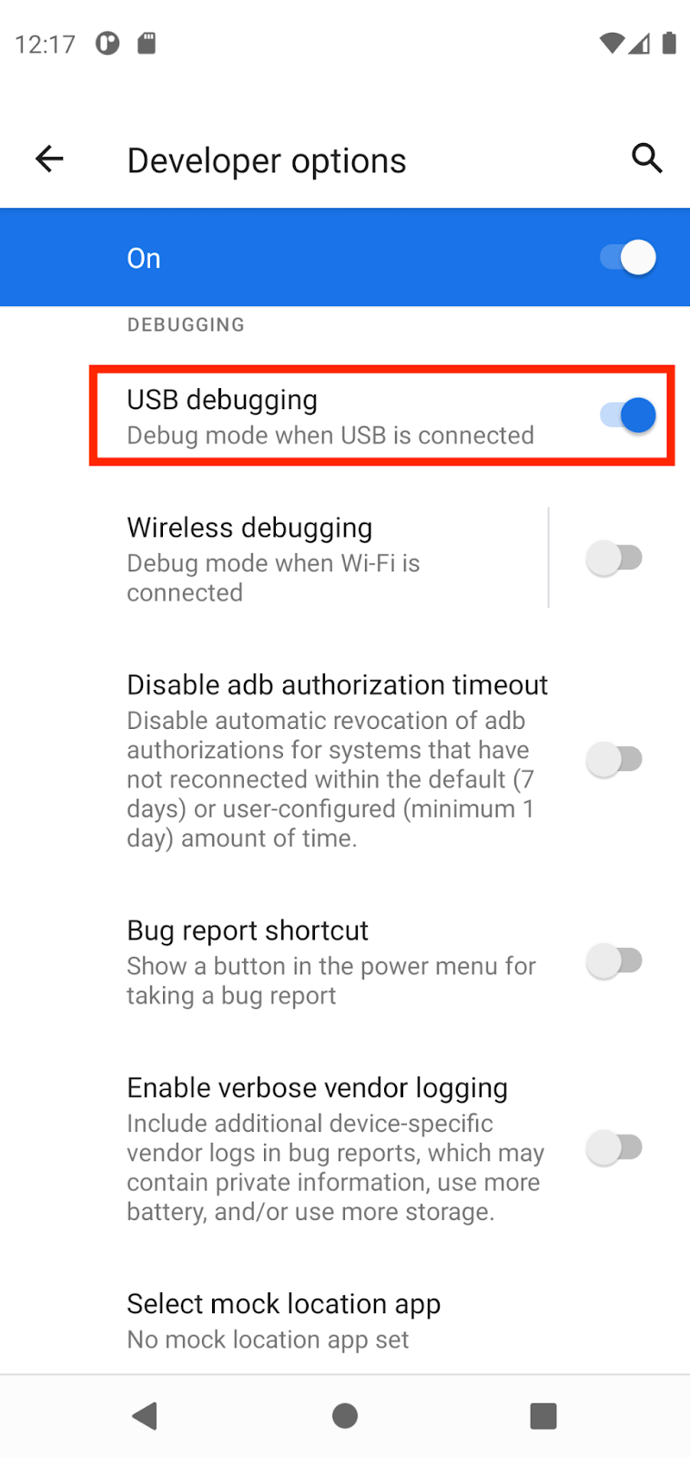 Opsi developer Gambar ini akan menampilkan halaman Opsi dengan tombol proses debug USB diaktifkan dan kotak berwarna merah.