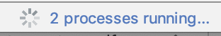 A imagem mostra uma barra de progresso girando e o texto diz &quot;2 processes running…&quot; (dois processos em execução).